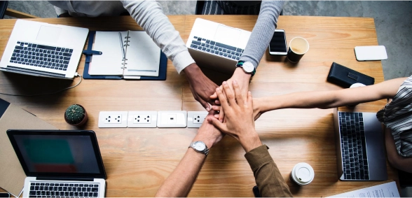 Employees hands down together